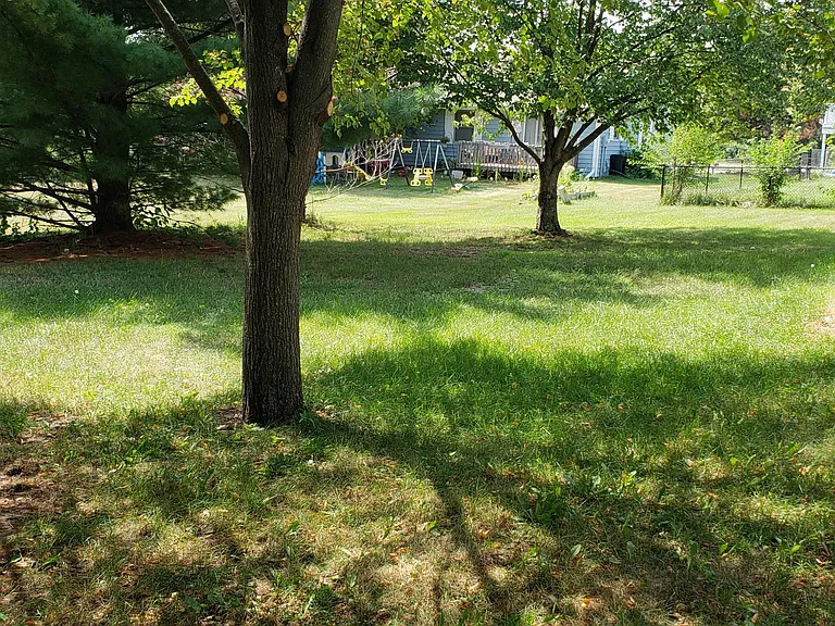 Back yard property line is not fenced. Two sides are fenced and front yard 
has fencing too. Large open back yard area behind property line so no backyard neighbors