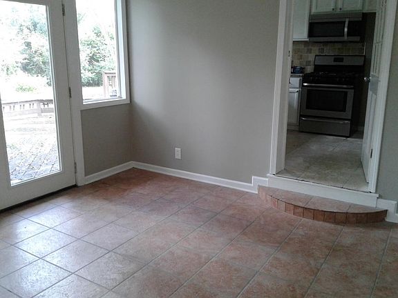 Sunroom enters kitchen and backyard to large deck