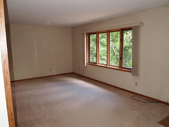 Apacious living room with knotty pine wall