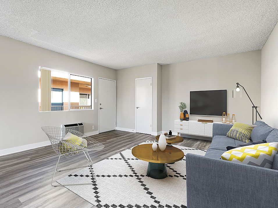 Spacious hardwood floor living room with view of courtyard.