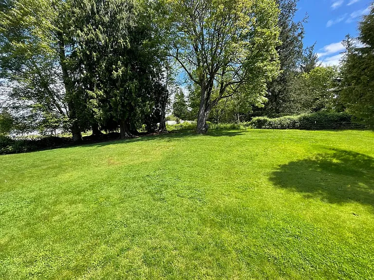 Expansive private backyard with mature trees and plenty of room to relax, garden, or entertain