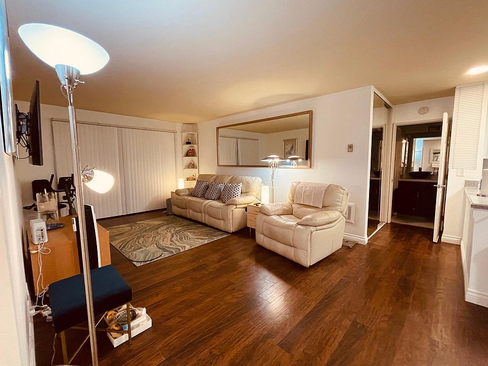 Sizable living room with reclining chair/sofa and large screen smart TV