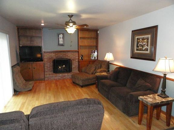Family room open to the kitchen and overlooks the back-yard setting, deck and pool