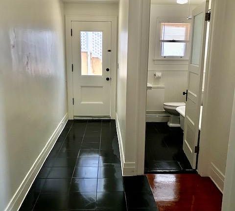 Main entrance, security screen door (not shown), New tile and refurbished bathroom maintaining vintage qualities