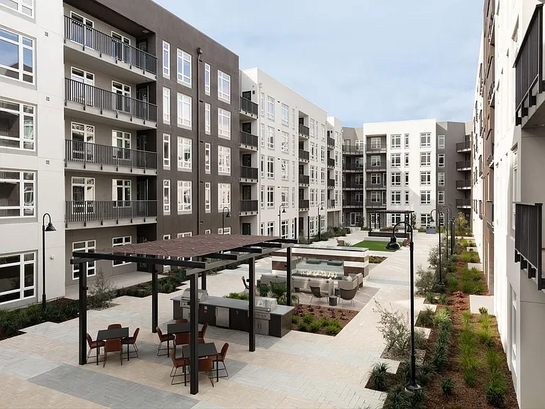 East Courtyard with lounge seating, fire feature, and grill stations