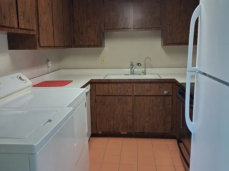 Another view - plenty of cabinet storage with washer and dryer and dishwasher.