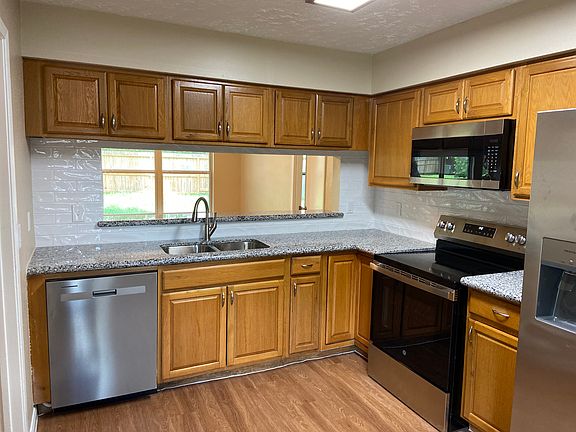 The kitchen has a bar and a view of the huge backyard!