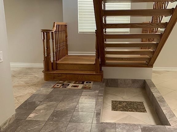 Grand staircase at entry of home