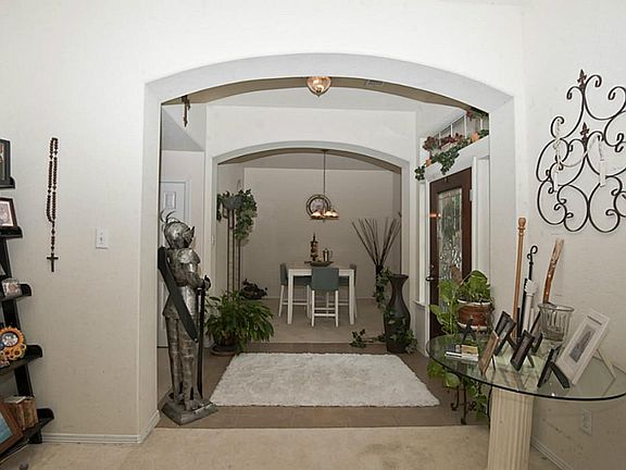 View from the formal living room looking back toward entry way and across to formal dining room. Thi