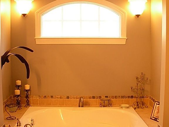 Master boasts jetted tub positioned under cathedral ceiling w/separate shower!