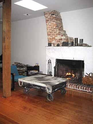 living room with large fireplace and skylight