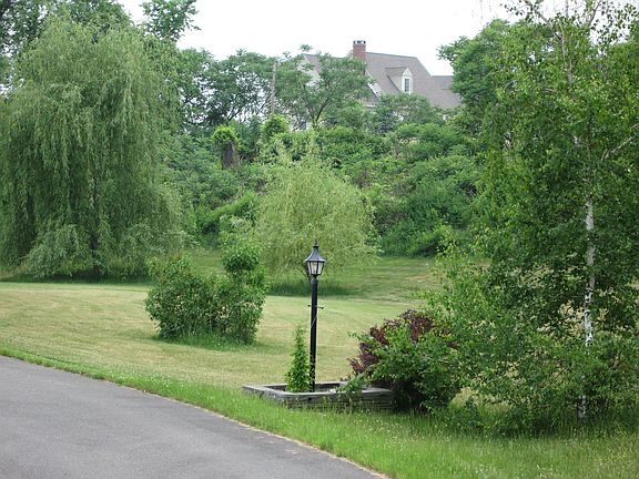 Driveway with view of back yard