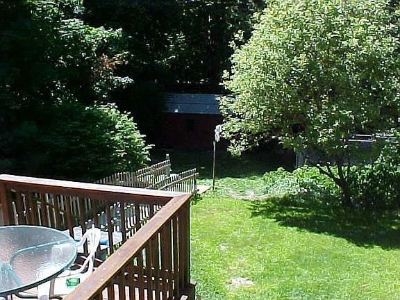 Deck overlooking fenced yard
