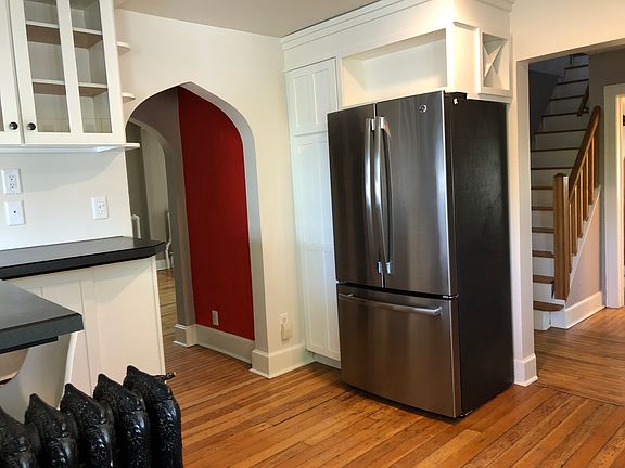 Built-in cookbook and wine bottle storage above the fridge.