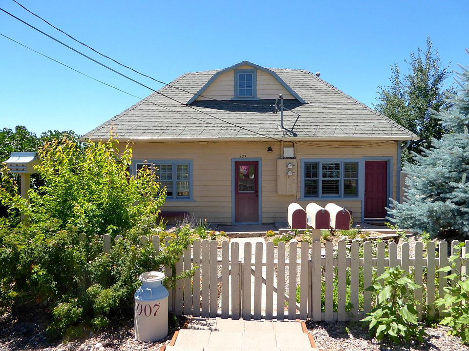 Lilac cottage on left with front door covered by foliage and next door, Willow cottage is on the right. Center door leads upstairs to storage.