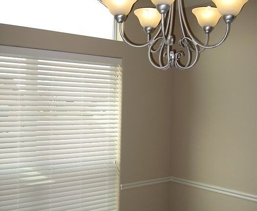 Dining room features chair rail molding and raised ceilings