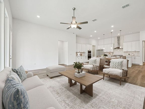 Bright open kitchen and family room with large island and connected seating space.