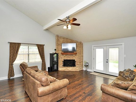 Den with corner gas log fireplace ,high ceilings and french doors to the back yard