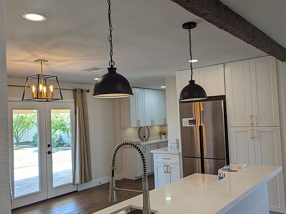 Looking from the hallway into the kitchen. The custom dark wooden beam helps delineate the living and kitchen space