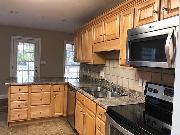 Kitchen with new stove, dishwasher, micro-wave and disposal.