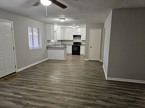 living room looking into dining area and kitchen