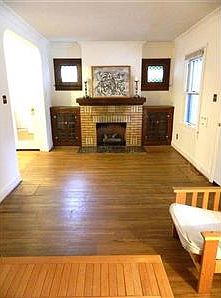 Living Room. Cozy Living Room has fireplace, leaded-glass, built-ins, and stained-glass windows.