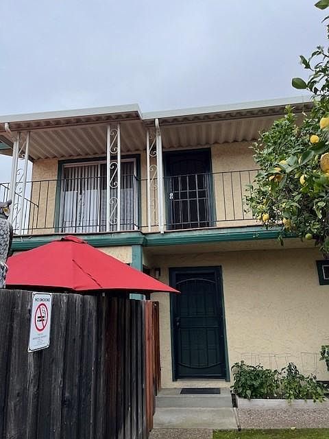 Photo from ground level showing upstairs front door and patio.
