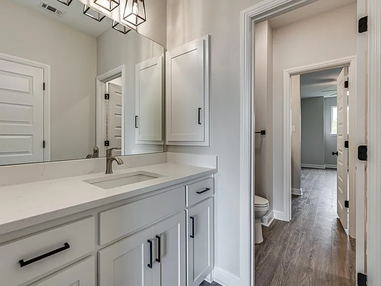Jack and Jill bath has a beautiful Quartz counter, extra cabinets, bath tub and medicine cabinet. All bedrooms come with ceiling fan with remote
