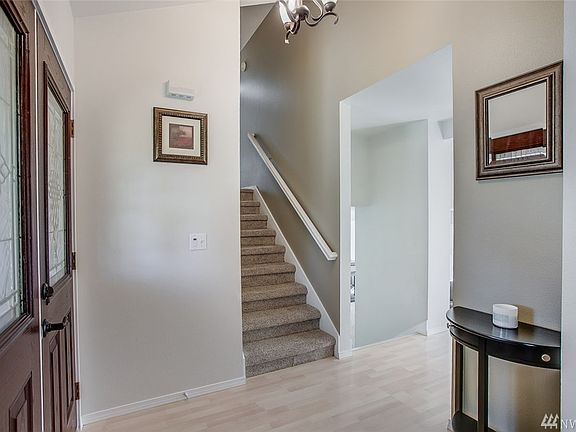 A two story entry with double doors is sunny and bright! You'll love the white doors and trim throughout the home as well as several skylights.