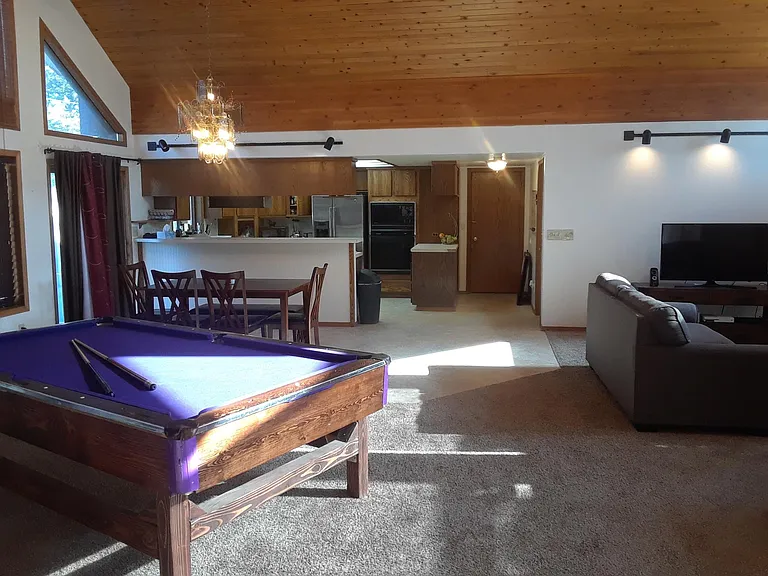 OPEN FLOOR-PLAN WITH OVERSIZED COMMON AREA BATHED IN NATURAL LIGHT BY 11 HUGE WINDOWS. VAULTED CEILINGS. REGULATION-SIZE POOL TABLE AND LARGE SCREEN TV.