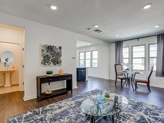 Living room with adjoining dining and half bath.