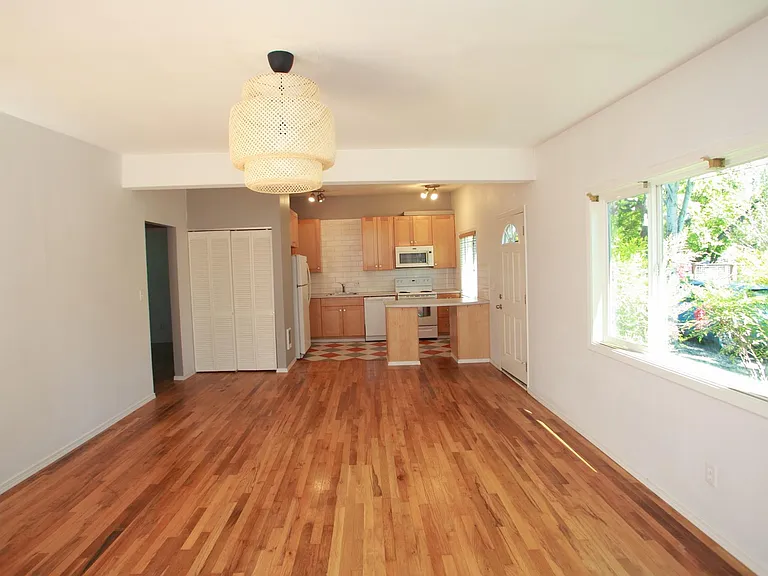 living room, coat closet and kitchen