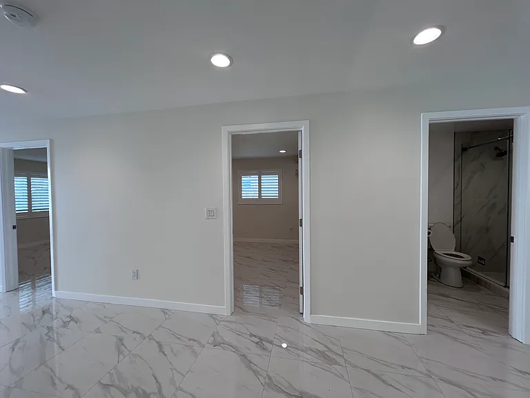 Bedroom 1 (left), Bedroom 2 and Bathroom 2 (center), Bathroom 1 (right)
