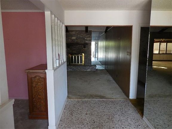 Entrance with dinning room to the left, living room ahead & hall to bedrooms & bathroom to the right.