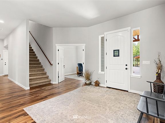 Ten foot ceilings greet you upon entering. Stairs lead up to the bonus room, half bath and wet bar. 