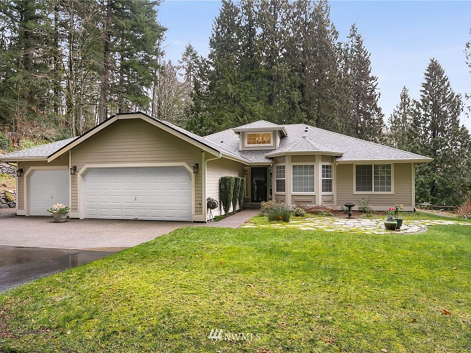 Welcome home to this beautiful custom rambler set among the trees!