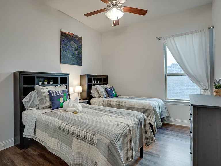 3rd bedroom with two twins and walk in closet and dresser