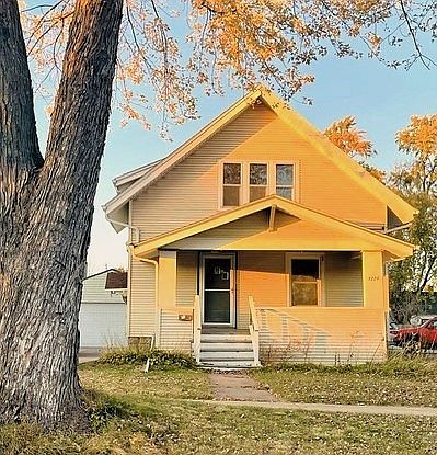 Front view of home from W. Winnebago St. Propety's garage and driveway peeking in on the left.