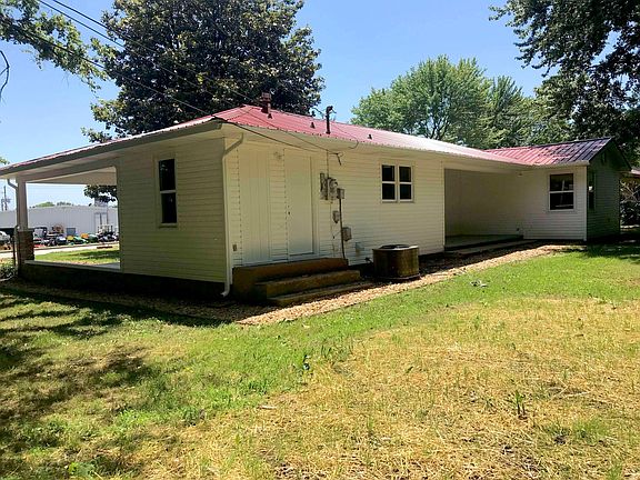 Back of house with steps going into laundry room