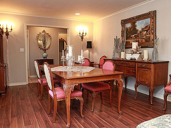 Another view of the living/dining room shows the entry foyer just beyond the table.