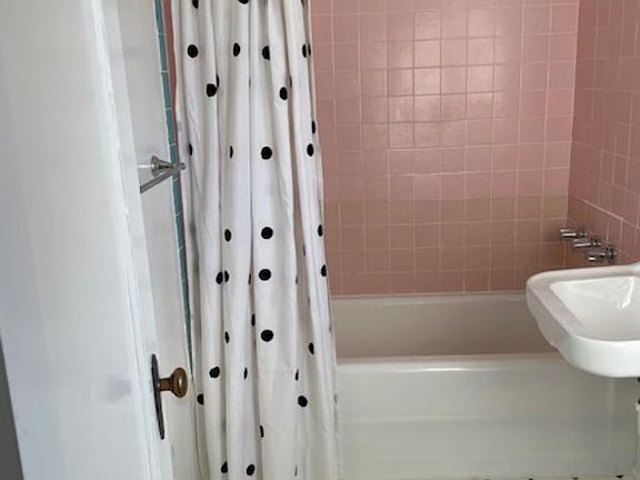 Full bath with shower over tub.