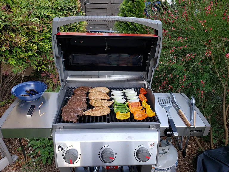 Communal gas grill in front yard.