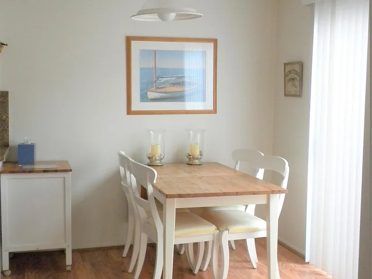 1st Level - Dining Area; Laminate Flooring; access to small patio through a sliding glass door (excludes furnishings)