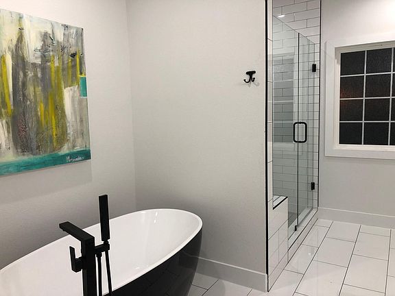 Retreat to sleek master bath with luxurious tub and large shower w/ dual-shower heads/sprays