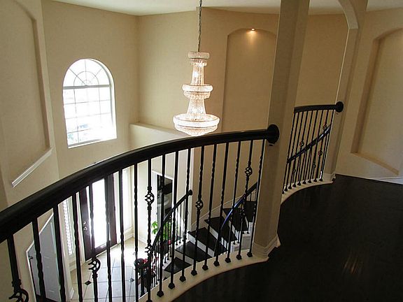 Another view of beautiful wrought iron staircase overlooking the foyer area