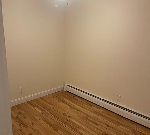 1st Bedroom with ceiling fan, skylight and closet.