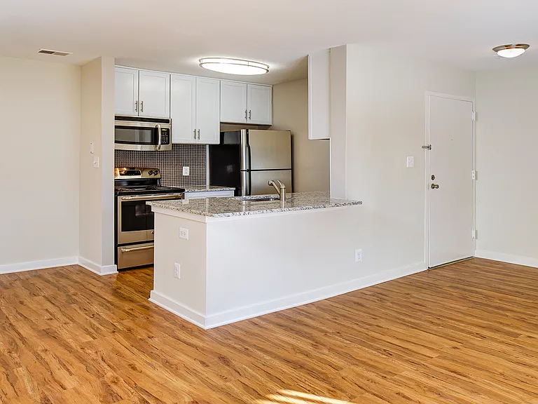 Large living room area with wood flooring throughout