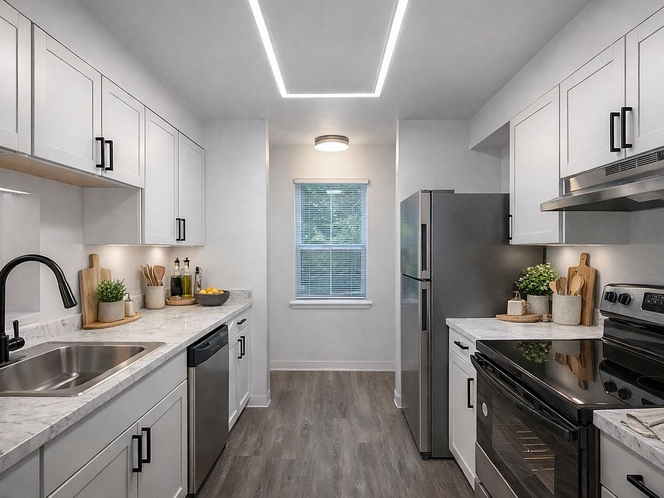 Modern kitchen with sleek appliances and greenery