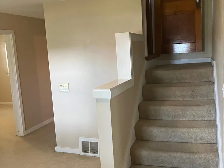 Stairs in living room leading to upstairs bedroom