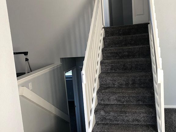 Photo taken from front entry to the stairway heading up to 2nd floor - laundry at top of stairs to the right in the closet. Master Bedroom at top of stairs to the left.